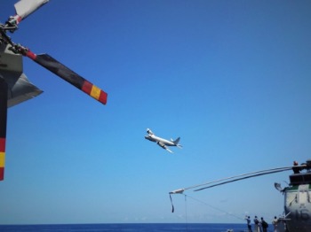 A German Navy P-3C CUP Orion passes ESPS Galicia (photo: EUNAVFOR)